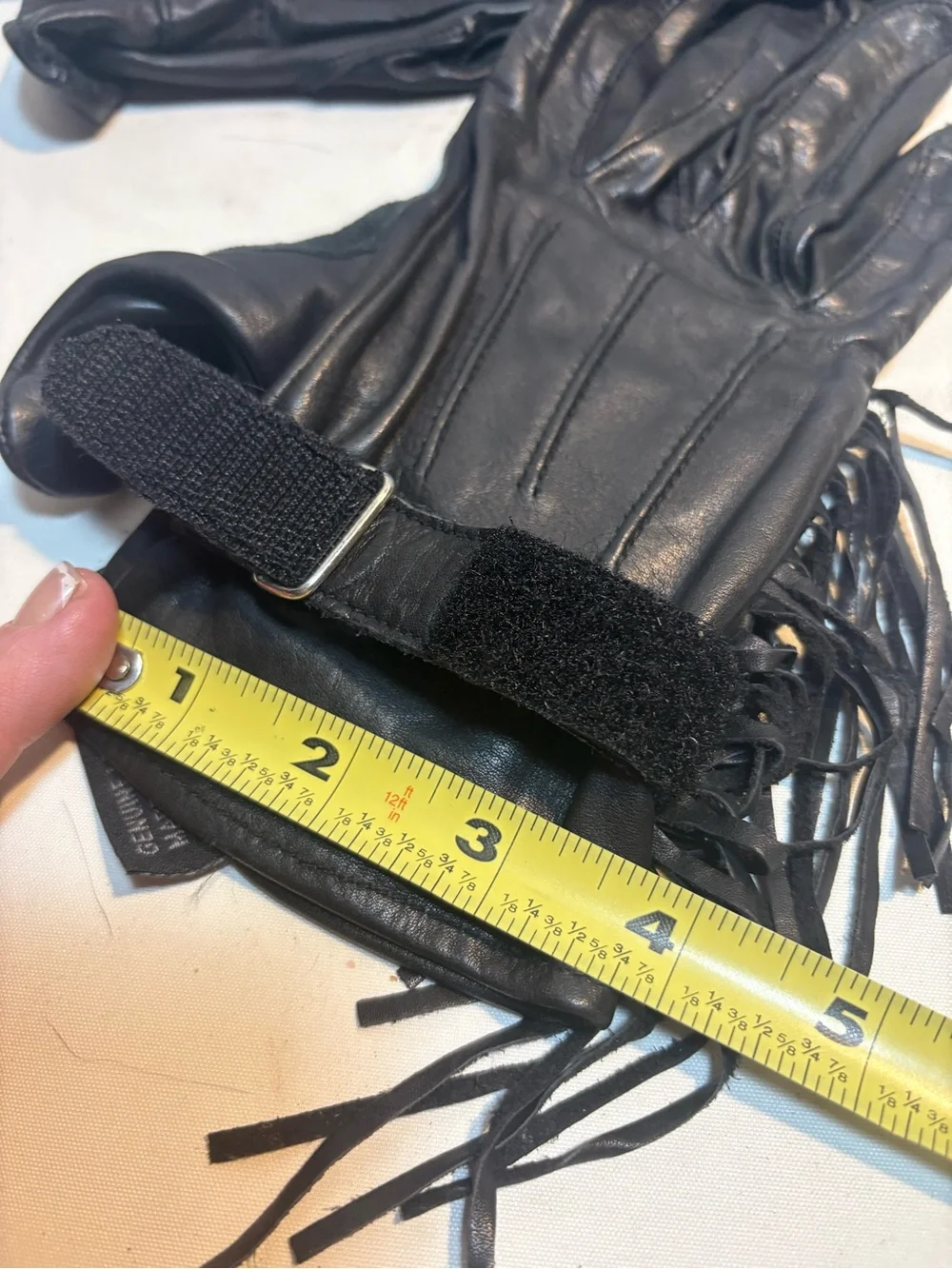 Women’s black leather motorcycle gloves fringe detailing adjustable closure